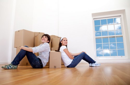 Staff using PPE while handling boxes and furniture