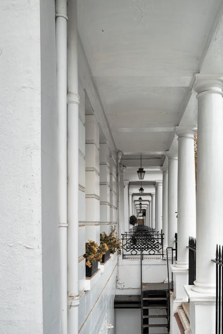 A quiet residential street in Bayswater with a row of Victorian-style terraced houses featuring bay windows, decorative brickwork, and terracotta chimneys. The pavement runs alongside the houses, with